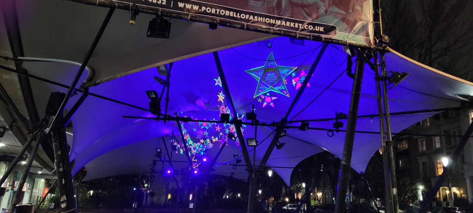 Blue purple glow of handcrafted stars underneath Portobello canopy
