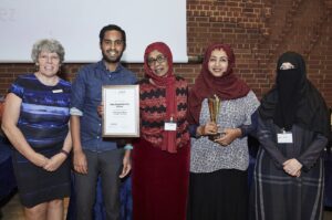 photo of a group with their award and certificate