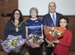photo of a group with flowers at an awards ceremony