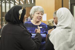 photo of three people speaking at an awards ceremony