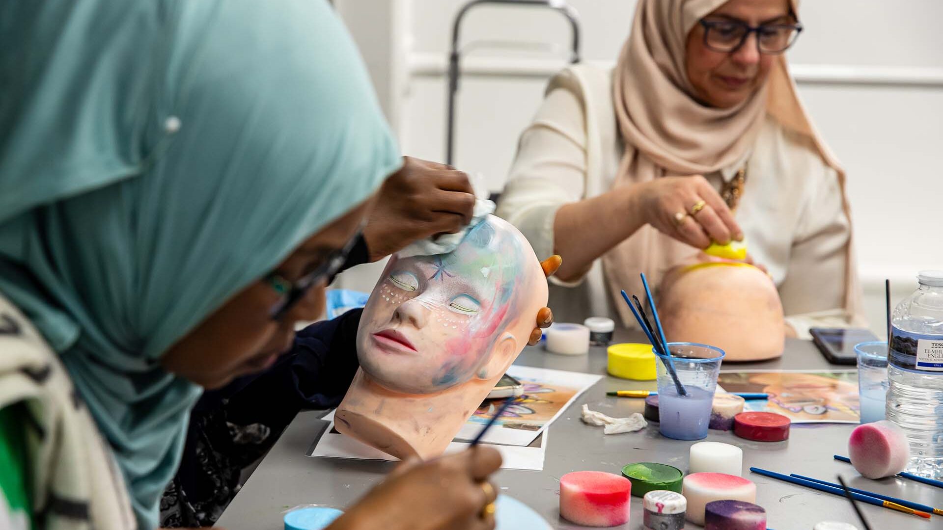 People taking part in face painting class
