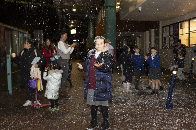 Children playing in snow under Westway